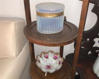 three tier shelf with glass and china on it