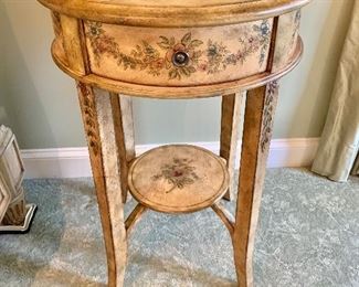 Round, painted table with drawer