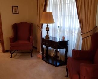 Matching Wing Chairs.  Ornately carved table with drawer