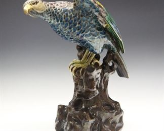 A Chinese Porcelain Figure of an Eagle. Polychrome and gilt decorated figure of an Eagle perched on a rocky base. Unmarked. Light wear to the gilding. 12" high.