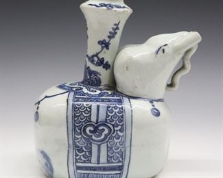 A Persian Safavid Period Kendi pouring vessel. Elephant form with Blue/Black underglaze decoration. Wear, glaze defects and minor damage, small flake on upper rim. 7 1/4" high overall.