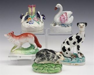Five pieces of 19th century Staffordshire includes three small animals and two inkwells. The animals are a seated Dalmatian, a Fox and a Rabbit, with a Swan and Doves inkstands. All with molded bodies and polychrome decoration. Minor surface wear, crazing, one Dove has a repaired neck and wing chips . Up to 4 3/4" high.