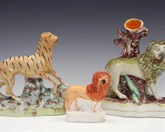 Three 19th century Staffordshire figures includes a small Lion, a Tiger and a Lion spill vase. Molded bodies with polychrome decoration. All with minor wear, the spill with some flaking to the paint. Up to 6 3/4" high.