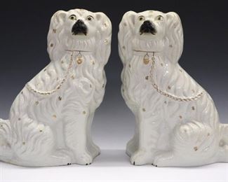A pair of late 19th century Staffordshire dogs. Traditional molded Spaniels with painted detail. Wear, kiln shrinkage and overall crazing. Each 14 1/4" high.