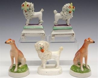 Two pairs 19th century Staffordshire dog figures includes seated Whippets, standing Poodles with Doves in their mouths. Molded bodies with polychrome decoration. All with minor wear, crazing, flakes on Poodle's tails. Up to 4" high.