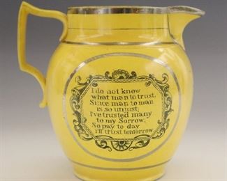 A 19th century English Canary Yellow jug with Silver lustre decoration. Landscape vignette with a Manor house at one side with the tavern keepers motto verso "I do not know, what men to trust, Since man to man, is so unjust, I've trusted many, to my sorrow, So pay today, I'll trust tomorrow". Wear and minor edge flaking. 6" high.