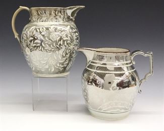 Two 19th century English Pearlware jugs with Silver lustre decoration. One with flowers and foliage the second with Parrots in foliage. Wear, crazing, light surface scratches, shallow edge flakes, 1/2" spout hairline in the Parrot jug, the other with some staining. Up to 8" high.