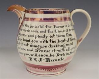 An early 19th century Dixon, Austin & Co. jug with Sunderland lustre decoration. Transfer vignette with "Farmers Arms" at one side and farmer's motto verso "Let this be held the Farmers Cried, For stock seek out the Choicest breed, In peace and plenty let them feed, Your land sow with the best of Seed, Let not dung or drefsing need, Inclose and Draine it with all speed, And you will soon be rich in Deed. P & J Rundle". Wear, crazing and minor edge flaking. 6" high.