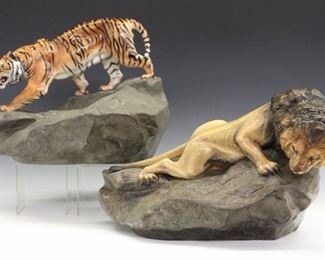 Royal Doulton Porcelain Figures of a Lion & a Tiger. Each depicted on a rock, looking down. Both with Royal Doulton mark at the underside along with artists' initials, "HN 2641 EAW" and "HN 2639 JC" respectively. Very minor wear overall. Up to 18 x 12 x 11" high.
