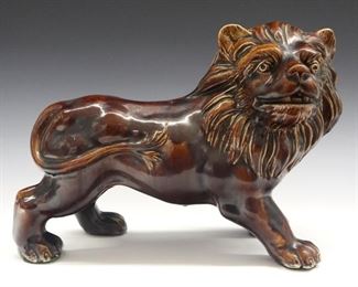 A 19th Century Ceramic Lion with Rockingham Glaze. Finely molded large figure of a lion standing covered overall with a treacle colored crackle glaze. Unmarked. Very minor wear overall. 14 3/4 x 10 3/4" high.