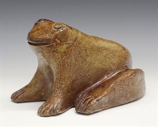 A Late 19th to Early 20th Century Sewer Tile Frog Doorstop. With reddish brown glaze overall, incised "RLW" at the underside. Some firing cracks and small chips to the toes. 6 3/4 x 9 x 5 1/4" high.