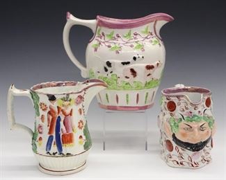 Three 19th century English Pearlware jugs with Pink lustre decoration. Molded bodies with enamel decoration. Includes a Satyr Mask jug, another with Hunting dogs and the third with a couple walking. Wear, crazing, loss to the enamel. Up to 7 1/4" high.