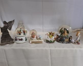 Three snow globes and three figurines