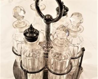 Lot #62  Victorian condiment set with silverplate caddy  25.00.  One piece has chip to the lip.