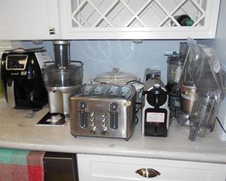 small elect. kitchen appliances by Breville coffee maker, Nutri Bullet, Puls, Hamilton Beach grinder, Corning ware crock pot, Crux toaster, Breville juicer, Zenchet Air Fryer, Nespresso,