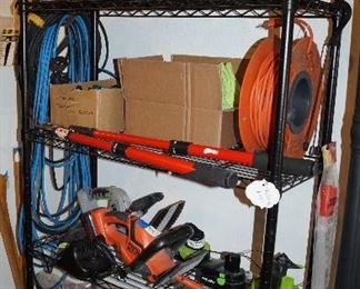 shelving, extension cords, electric chain saw, tools, weights, 