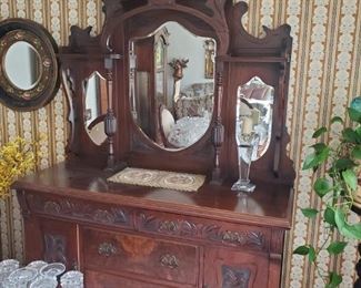 Antique dining room hutch. Candle holders on hutch and crystal glasses on table also for sale.