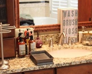 The bathroom has lots of accessories and towels.  