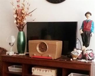 Samsung 30 inch flat screen TV and Western Auto vintage radio on tv stand with shelves