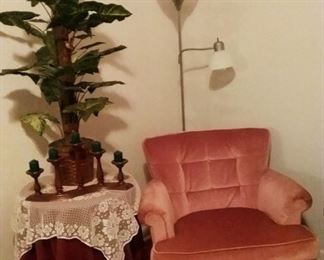 Vintage  pink velvet armchair one of matching pair. Pole lamp, small composite  round table with artificial  plant.