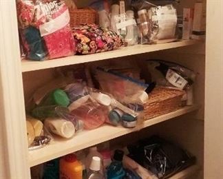 Hallway closet filled with bagged health and beauty products.  Foot bath and sauna items in plastic  container. 