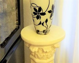 Black and white vase with white pedestal 