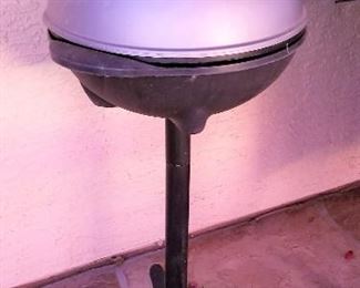 Small grill that has a canvas cover