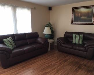 Bonded leather sofa and loveseat.  1 of two table lamps, 1 of 2 end tables, artificial tree, framed print