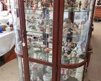 Beautiful curved glass curio cabinet.  Has over 7 glass shelves and lighted