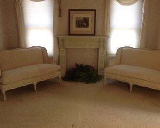 Master Bedroom: Two matching down filled settees by SAM MOORE are upholstered in a beautiful ivory fabric. They flank a faux fireplace surround, print and ferns. Closer photos are coming up!