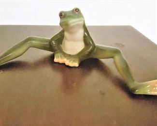 This cute little fellow is ceramic and signed