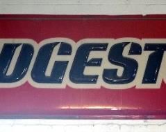 Acrylic "Bridgestone" Sign, 2' 8" x 12' x 3", Attached To Wall
