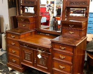  c. Late 1800's, English, Ornately Carved Dresser with Original Beveled Mirror (small crack in corner), with 2 Double Drawers on each top side with Small Beveled Mirrors, 8 Bottom Side Drawers, 1 Center Drawer and 2 Carved Front Doors