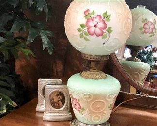 c.1930's, "GONE WITH THE WIND" electric table lamp with hand painted details, raised wagon wheels and flourishes, as well as a brass finish base and hardware, lights up on top and on bottom