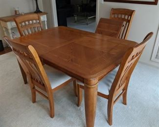 $200 Oak Kitchen table with four chairs, one 18" leaf. Measures 40" x 60"