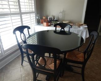 Pottery Barn Round pedestal table with four rush seat chairs.  Beautiful beveled glass top for table included
