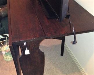 This drop-leaf table is pictured with a flat screen Samsung TV.