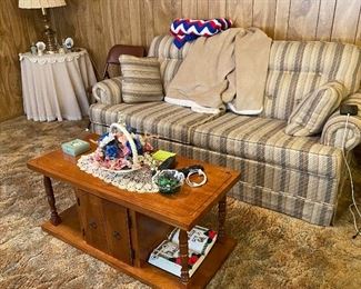 Serta Sleeper Sofa , Coffee Table, Round Spindle Table, Brass Lamp, Assorted Collectible Bells, Hand Crocheted Red, White, Blue Blanket, Sonoma Throw Blanket