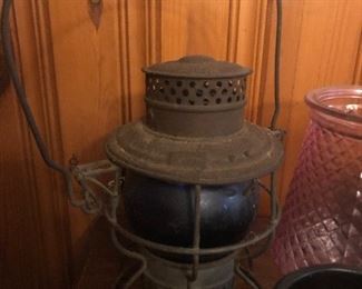 Antique railroad lantern with blue glove 