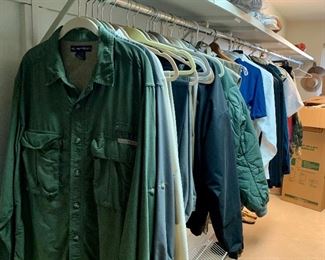 Closet full of men's ware, military garments, suits, shirts and more. 