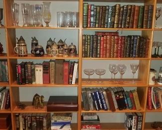 Nice library full of books, barware, pilsner glasses, German mugs / stiens and more decor.  