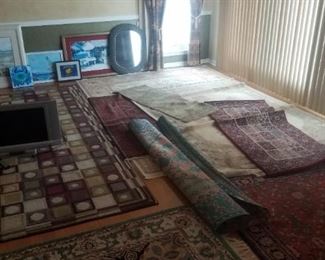 Room full of rugs / carpets. 