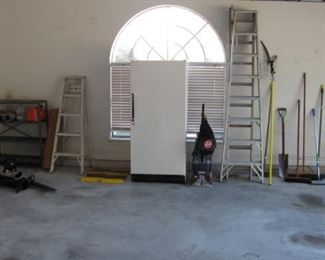 yard tools, full size upright freezer, ladders and more in garage. 