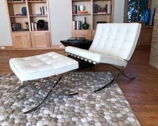 Knoll Barcelona Chair & Ottoman in Creme..Designed by Ludwig Mies van der Rohe, produced by Knoll®. Crate & Barrel sculpted ‘Pebble’ Room-sized Rug.