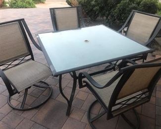 48" square outdoor glass table and 4 swivel chairs
