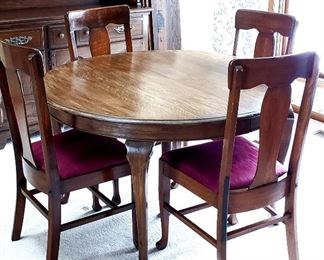 Round dining table, four leaves & four slat back chairs