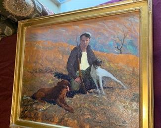 An oil painting scene of hunter and two dogs by listed American artist Howard Buck (20th Century), created in the 40’s. Portrayed with loose expressionistic brushstrokes and vibrant colors. The painting is signed to the lower right. It is presented in a bronze-tone gesso frame with an abstract decorative pattern and a gold-tone edge. approximately 29.5" W x 23.5" H.  $100