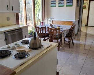 View of kitchen set with wooden bench. Will need to be refinished as chairs, table and bench are not matching in color