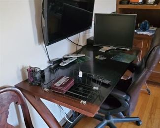 desk with hanging monitor