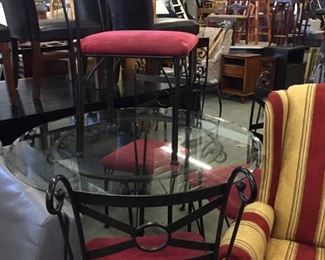 glass table and four metal chairs
